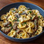 Creamy beef and garlic butter pasta in a cast iron skillet.