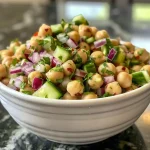 Detailed image of Mediterranean Chickpea Salad with bright vegetables, chickpeas, and herbs displayed prominently.