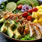 Juicy Hawaiian chicken salad with colorful vegetables and quinoa in a bowl.