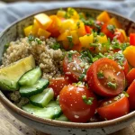 A healthy vegetarian meal with quinoa, fresh veggies, and a lemon dressing.