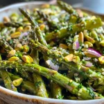 A detailed shot of a salad showcasing green asparagus, grated cheese, and toasted nuts.