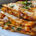 Delicious quesadilla cut into triangles, revealing cheese and chicken filling.