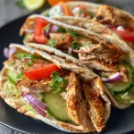 Delicious shawarma wraps filled with spiced chicken, lettuce, and yogurt sauce.