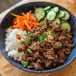 A close-up side view of a Beef Bulgogi Bowl filled with rice, beef, and colorful toppings.
