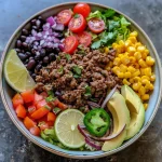 Close-up view of a Ground Beef Burrito Bowl with vibrant ingredients.