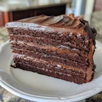 Side view of a decadent Hershey chocolate cake with rich chocolate frosting.