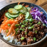 A close-up view of a Korean Beef Bowl topped with spicy mayo and garnished with green onions.