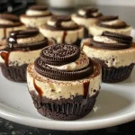 Close-up view of a mini Oreo cheesecake topped with crushed Oreos.