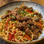 Juicy Teriyaki Beef Noodles with colorful vegetables, close-up shot.