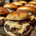 Close-up view of juicy air fryer sliders stacked on a plate.