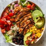 Close-up view of a Chicken Burrito Protein Bowl with colorful ingredients.