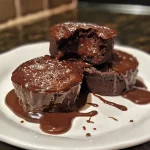 A close-up view of a chocolate lava cake with a molten chocolate center.