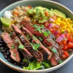 A close-up view of a steak burrito bowl filled with ingredients including steak, rice, beans, and toppings.