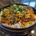 ['A close-up view of a Beefy Garlic Butter Bowl showcasing juicy ground beef, melted cheeses, and garnished with fresh parsley.', 'A side view of a hearty Beefy Garlic Butter Bowl with glistening garlic butter and creamy textures.', 'An appetizing Beefy Garlic Butter Bowl filled with ground beef, rice, and a rich sauce, highlighted by herbs.', 'A detailed close-up of a Beefy Garlic Butter Bowl, emphasizing layers of cheese, beef, and aromatic garlic.']