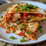 ['Close-up view of a cheesy salsa chicken quesadilla with colorful ingredients.', 'Side view of a juicy quesadilla filled with shredded chicken, cheese, and salsa.', 'Detailed image of a quesadilla showcasing melted cheese and vibrant peppers.', 'Mouth-watering close-up of a cheesy quesadilla with a golden-brown tortilla.']