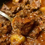 ['Close-up view of a bowl of Crockpot Hungarian Goulash with chunks of beef and seasonings.', 'Side view of a hearty serving of Hungarian Goulash in a rustic bowl, showcasing its rich texture.', 'Detailed image of delicious Crockpot Hungarian Goulash featuring tender meat and vibrant sauce.', 'Mouthwatering close-up of Hungarian Goulash with beef cubes and a glossy sauce, served in a deep dish.']