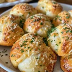 ['Juicy garlic parmesan knots glistening with melted butter and herbs.', 'Freshly baked garlic knots sprinkled with parmesan and parsley.', 'Close-up of delicious garlic knots, golden brown and rich in flavor.', 'Savory garlic parmesan rolls with a buttery glaze and a sprinkle of cheese.']