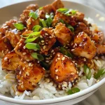 ['Close-up of juicy chicken pieces coated in sweet chili sauce with green onion garnish.', 'Side view of tender chicken bites drizzled in glossy sweet chili sauce, garnished with sesame seeds.', 'A detailed shot of Easy Sweet Chili Chicken showcasing vibrant sauce and fresh green onions.', 'Cooked chicken pieces glistening with sweet chili glaze, accented with sesame seeds and herbs.']