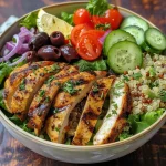 ['Juicy Mediterranean chicken breast garnished with fresh parsley, side view.', 'Close-up of a grilled Mediterranean chicken breast with herbs and lemon slices.', 'Seasoned chicken breast with a vibrant red onion and lemon, displayed on a plate.', 'Succulent Mediterranean chicken breast against a blurred background, highlighting textures.']