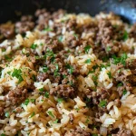 ['Close-up view of Skillet Garlic Butter Ground Beef and Rice, showcasing the juicy beef and fluffy rice.', 'Side angle of a serving of garlic butter ground beef and rice, with visible herbs and spices.', 'Delicious plate of ground beef and rice cooked in garlic butter, garnished with parsley.', 'Appetizing close-up of a skillet filled with ground beef, rice, and melted butter, highlighting the texture.']