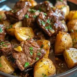 ['Close-up view of juicy garlic butter beef bites with baby potatoes in a slow cooker.', 'Side angle shot of tender beef stew meat and potatoes coated in garlic butter.', 'Crispy garlic butter beef bites and halved baby potatoes in a rich sauce.', 'Appetizing display of slow-cooked beef and potatoes garnished with parsley.']