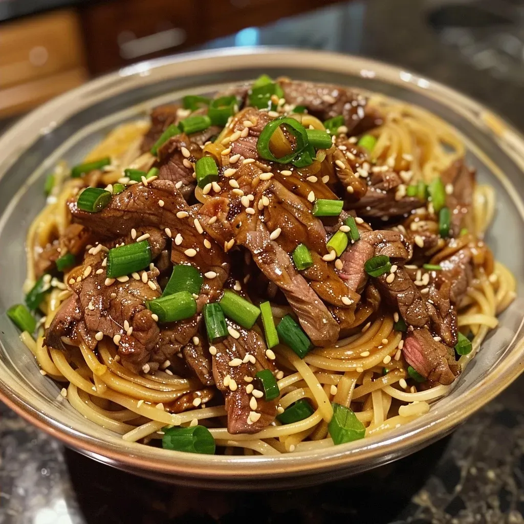 ['Close-up of juicy sticky beef noodles with a glossy glaze and colorful toppings.', 'Side view of a bowl filled with sticky beef noodles, showcasing tender beef and green onions.', 'Detailed image of sticky beef noodles, highlighting the rich sauce and garnishes.', 'Close-up of a delicious plate of sticky beef noodles, displaying vibrant colors and textures.']