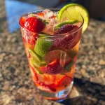 ['Close-up view of a refreshing Strawberry Coconut Lime Spritzer with vibrant strawberries and lime wedges.', 'Side view of a sparkling drink featuring coconut seltzer, ice, and fresh strawberries and lime.', 'Juicy Strawberry Coconut Lime Spritzer in a glass, showcasing bright colors and ice.', 'Refreshing beverage with a coconut seltzer base, garnished with strawberries and lime, viewed from the side.']