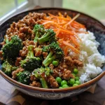 ['A side view of a plate filled with Teriyaki Ground Turkey, broccoli, and peas.', 'Close-up shot of juicy Teriyaki Ground Turkey with vibrant broccoli and peas.', 'A colorful dish featuring ground turkey cooked in teriyaki sauce, broccoli, and peas.', 'A detailed side view of Teriyaki Ground Turkey, showcasing bright green vegetables.']