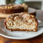 ['Close-up side view of a slice of moist Apple Cider Donut Bread on a wooden surface.', 'Detailed image of Apple Cider Donut Bread with a golden crust and crumbs.', 'Side view of freshly baked Apple Cider Donut Bread showcasing its texture and spices.', 'Juicy and delectable Apple Cider Donut Bread displayed in a rustic setting.']