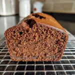 ['Close-up view of a moist gingerbread loaf with a rich brown color.', 'Side perspective of a freshly baked Classic Gingerbread Loaf showcasing its texture.', 'Detailed image of a gingerbread loaf highlighting its juicy interior and crusty exterior.', 'Close look at a classic gingerbread loaf, emphasizing its spices and moistness.']