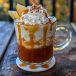 ['A close-up view of a glass filled with spiked caramel apple cider, showcasing a drizzle of caramel on top.', 'A side photo of a beverage, highlighting its rich golden color and caramel accents in a glass.', 'A detailed shot of spiked caramel apple cider in a glass, with visible caramel sauce and garnishes.', 'A visually appealing image of a drink featuring spiked caramel apple cider, emphasizing its inviting appearance.']