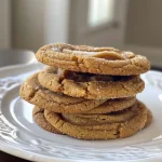 Close-up view of freshly baked apple cider cookies with a golden-brown exterior.