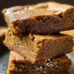 Close-up view of a slice of brown butter pumpkin blondies showcasing a golden-brown texture.