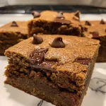 Close-up view of soft and chewy gingerbread chocolate chip bars with a rich texture.