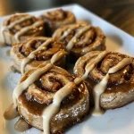 Close-up of juicy, delicious no-bake gingerbread cinnamon rolls with a glossy glaze.
