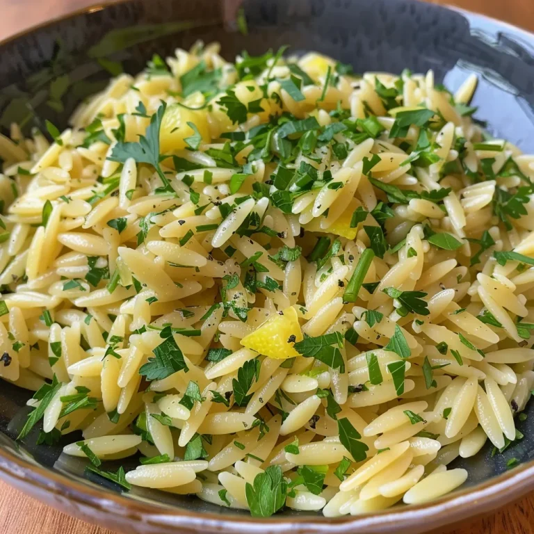 A Bowl of Sunshine: Lemon Herb Orzo That Brightens Every Gathering Close-up of Lemon Herb Orzo garnished with fresh herbs.